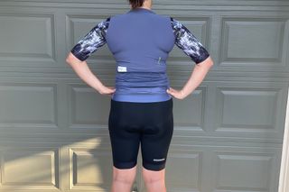 Woman cyclist wearing an Attaquer jersey and bib shorts