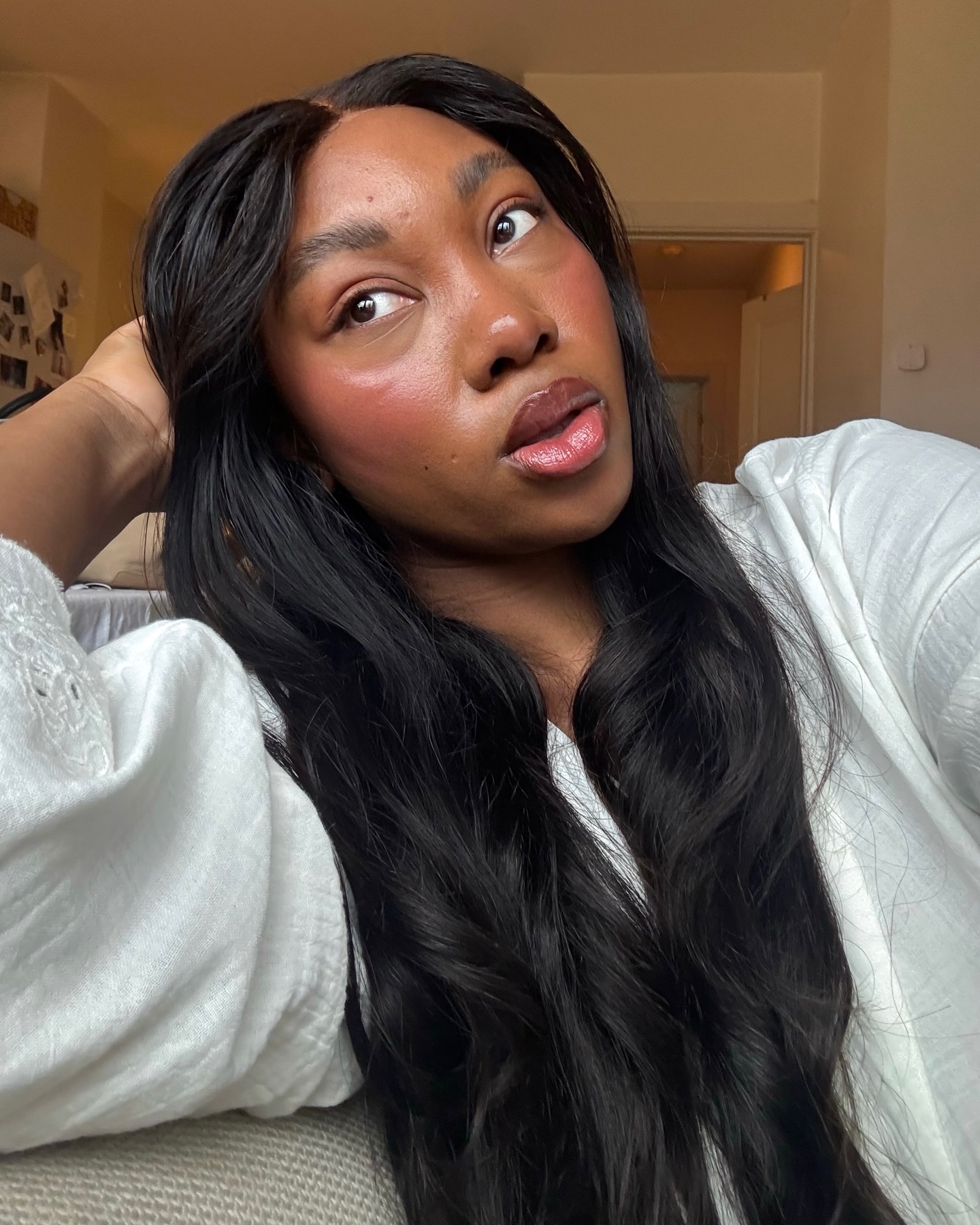 @nnennaechem wearing a glossy lip product