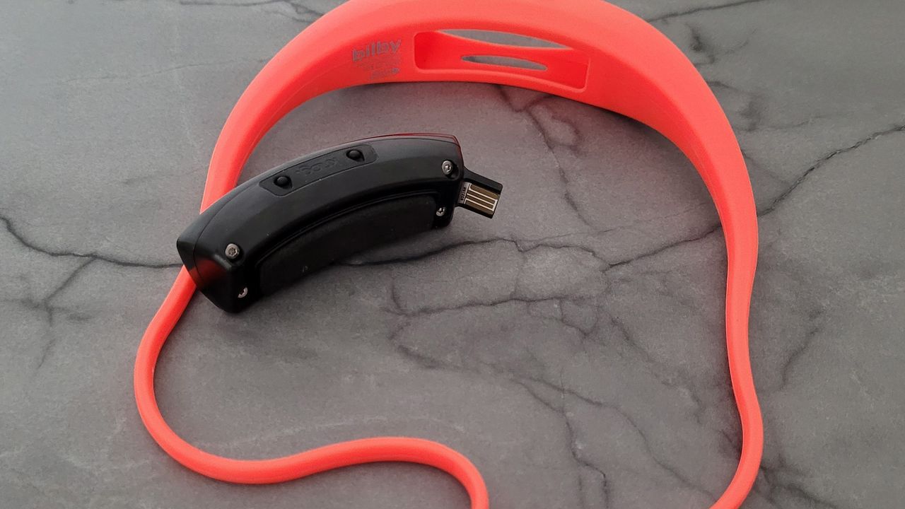 Knog Bilby headlamp with the light separated from the strap spread out on a table.