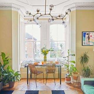 Dining area in the bay window of a period apartment
