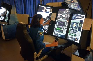 NASA astronaut Suni Williams uses hand controllers to undock the CST-100 Starliner from the space station during a simulation using Boeing’s Crew Part Task Trainer.