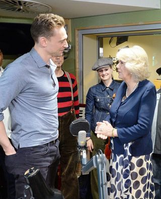 The Duchess of Cornwall meets Tom Hiddleston as she joined the judging panel for the station's 500 Words children's creative writing competition