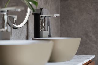 Two freestanding basins with silver taps