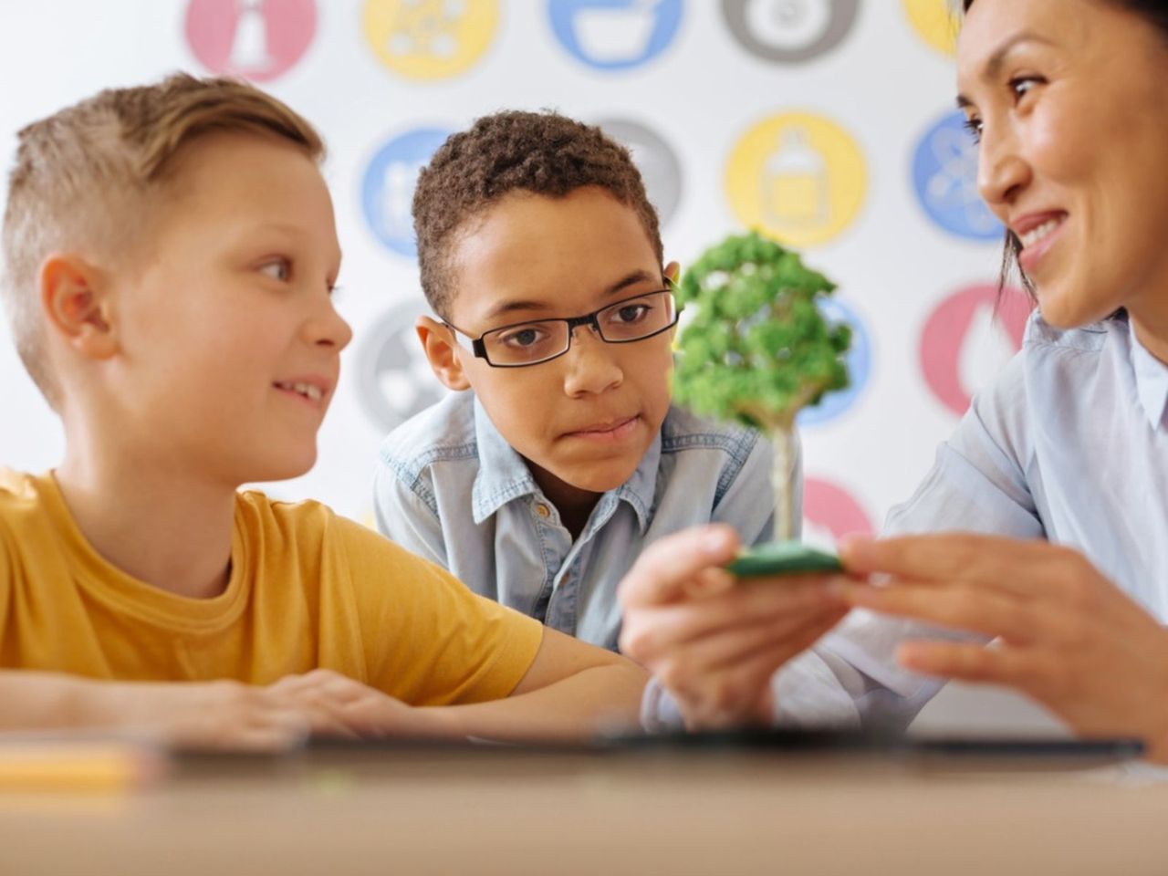 Kids And Adult Looking At A Model Tree