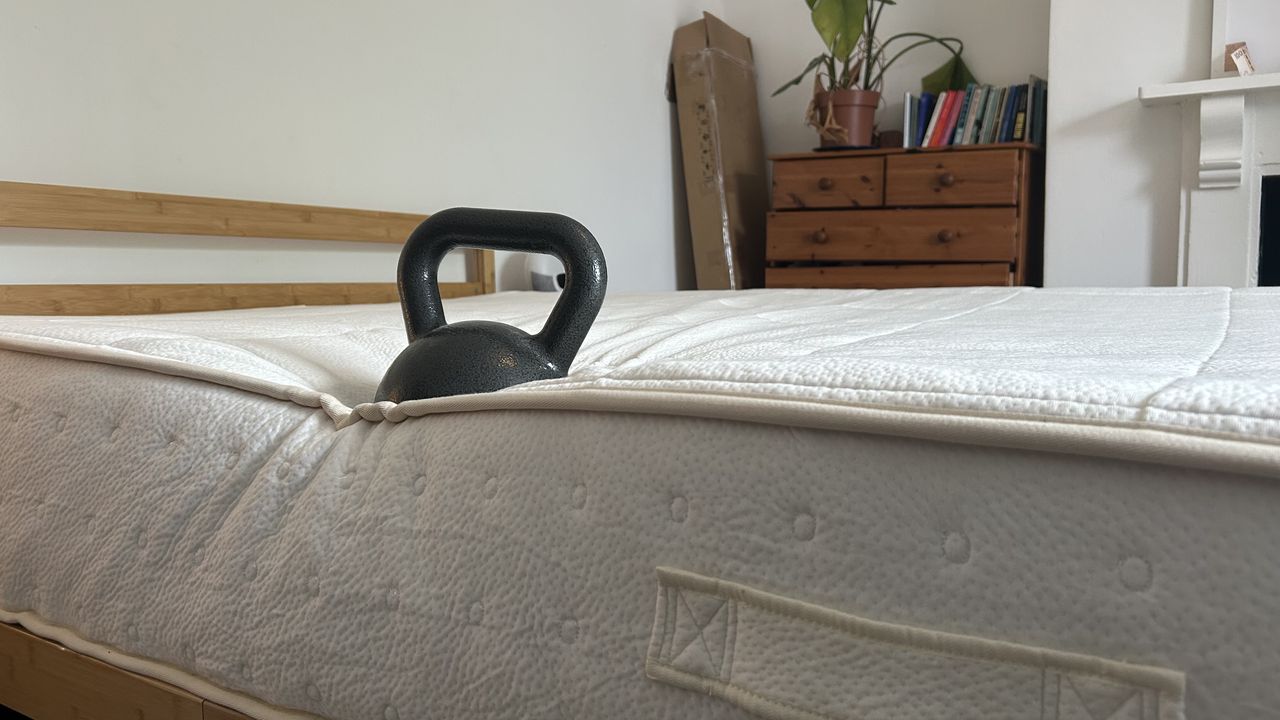 A weight on the edge of the Awara Classic mattress to test edge support