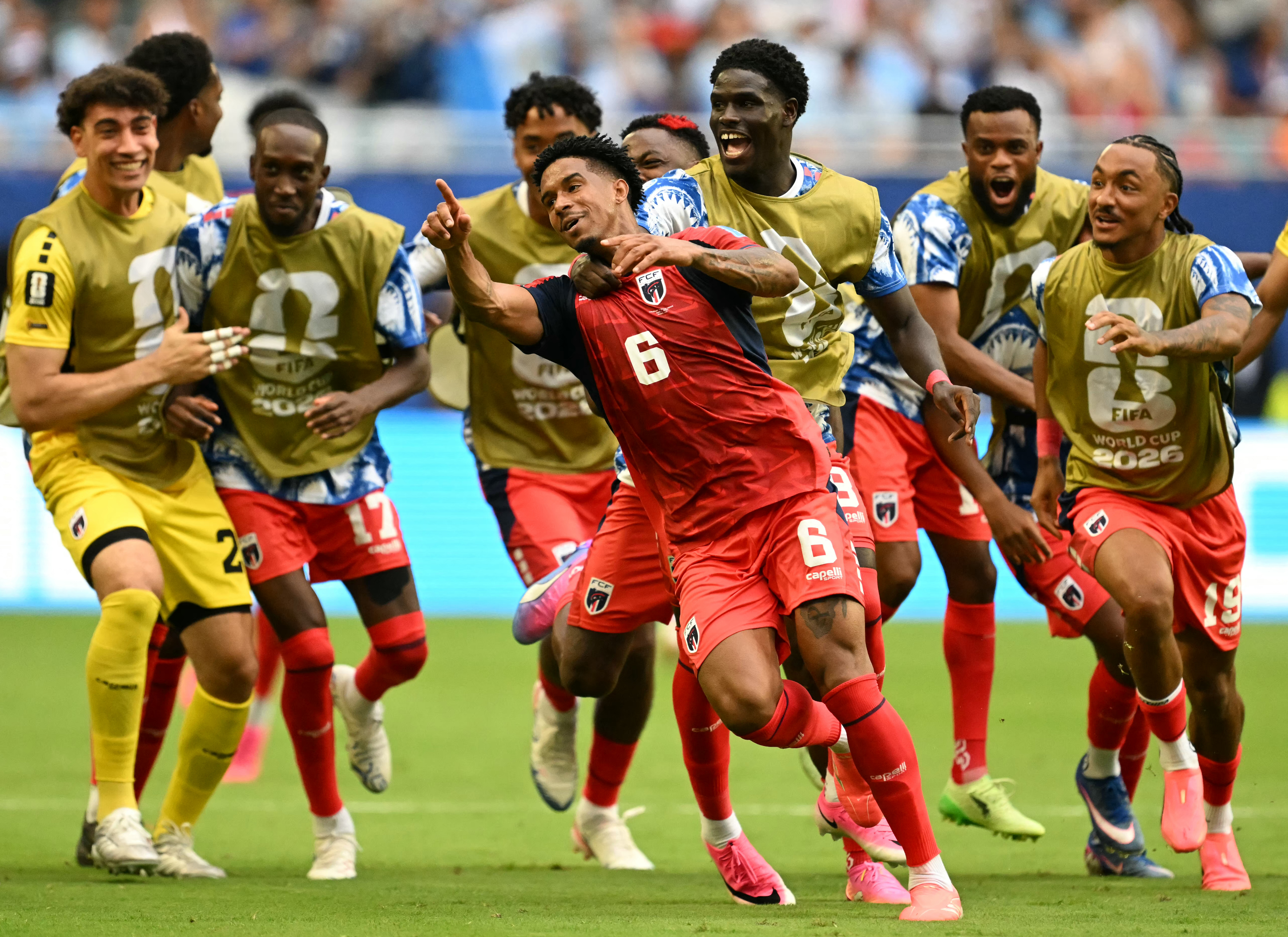 Cape Verde's midfielder #06 Kevin Pina celebrates with teammates after scoring his team's first goal during the 2026 World Cup Group H football match between Uruguay and Cape Verde