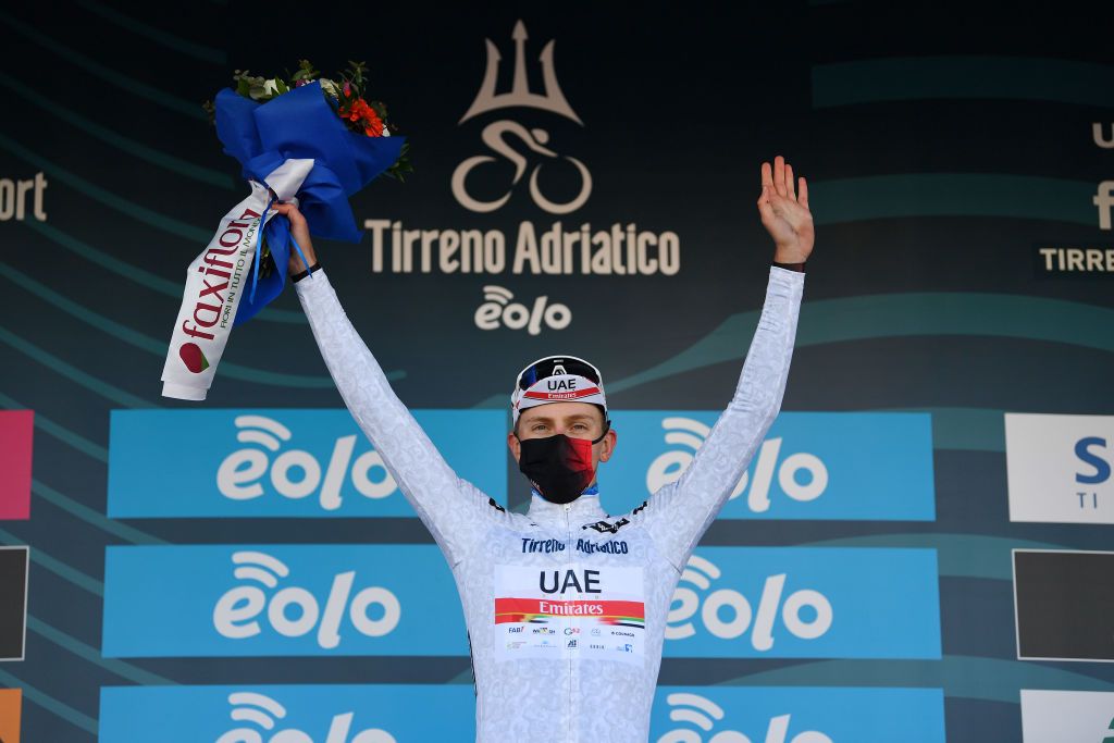LIDODIFERMO ITALY MARCH 15 Podium Tadej Pogacar of Slovenia and UAE Team Emirates White best young jersey Celebration during the 56th TirrenoAdriatico 2021 Stage 6 a 169km stage from Castelraimondo to Lido di Fermo Mask Covid safety measures Flowers TirrenoAdriatico on March 15 2021 in Lido di Fermo Italy Photo by Tim de WaeleGetty Images
