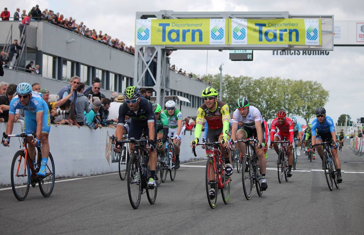 The other riders come across the line