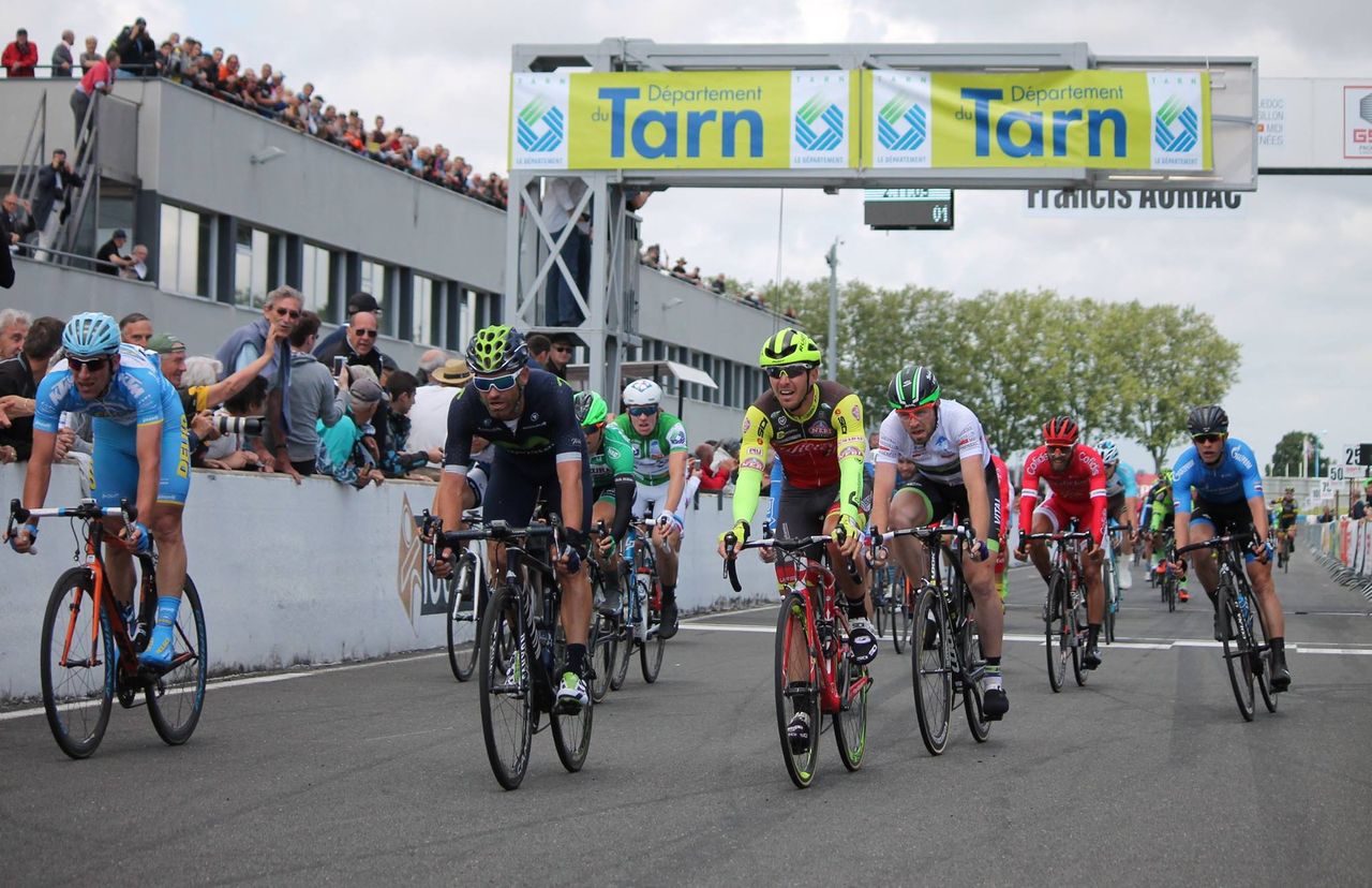 The other riders come across the line