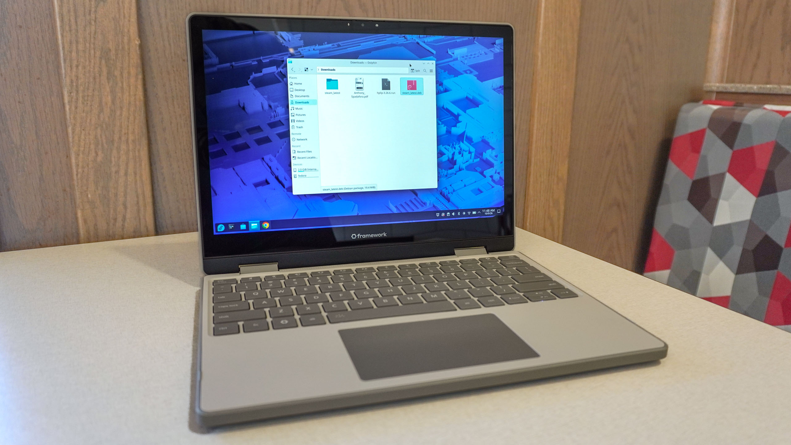 The Framework Laptop 12 open on a table with Fedora's File Explorer open