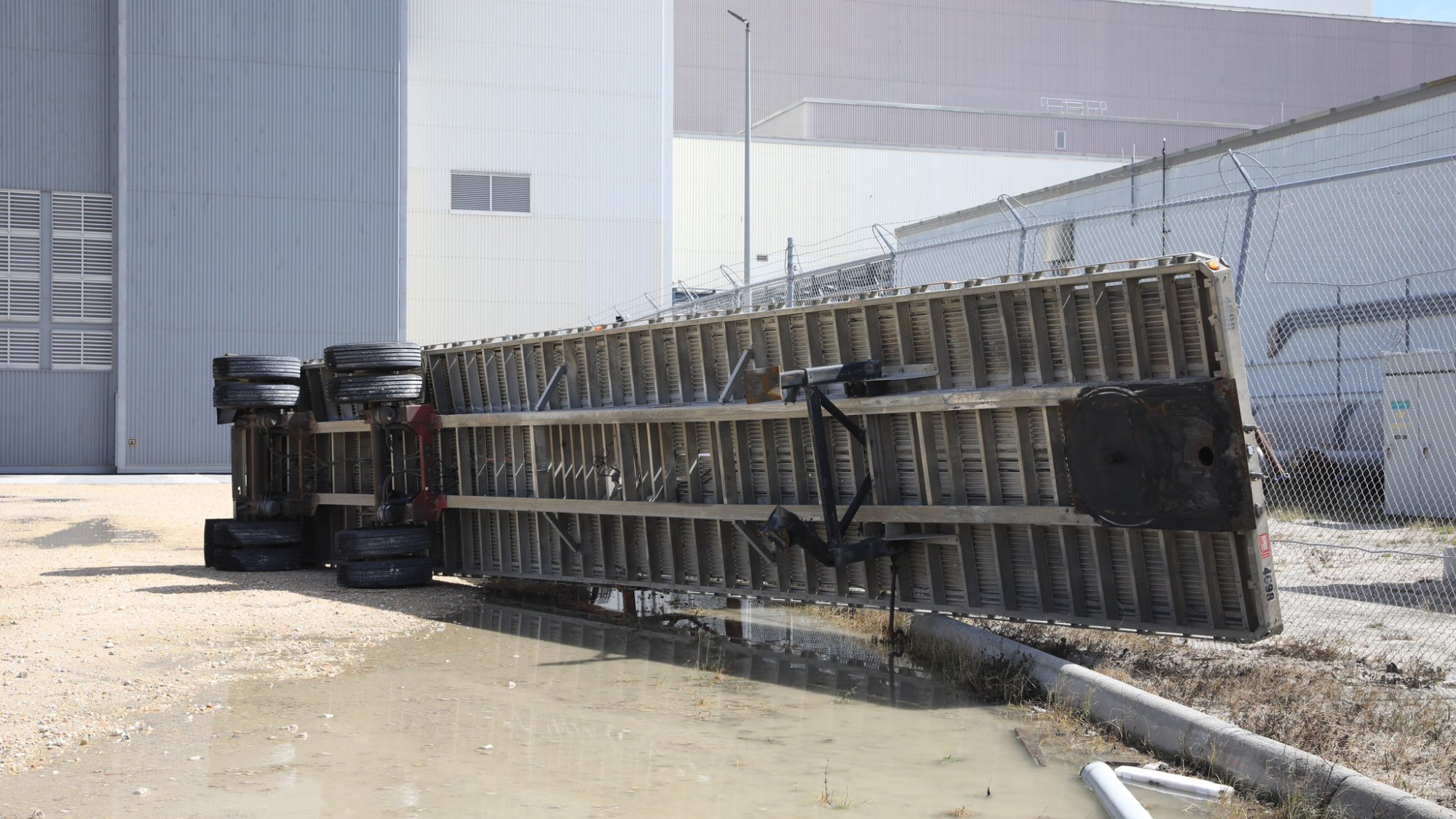 An overturned flatbed truck trailer on its side at NASA's Kennedy Space Center after Hurricane Milton.