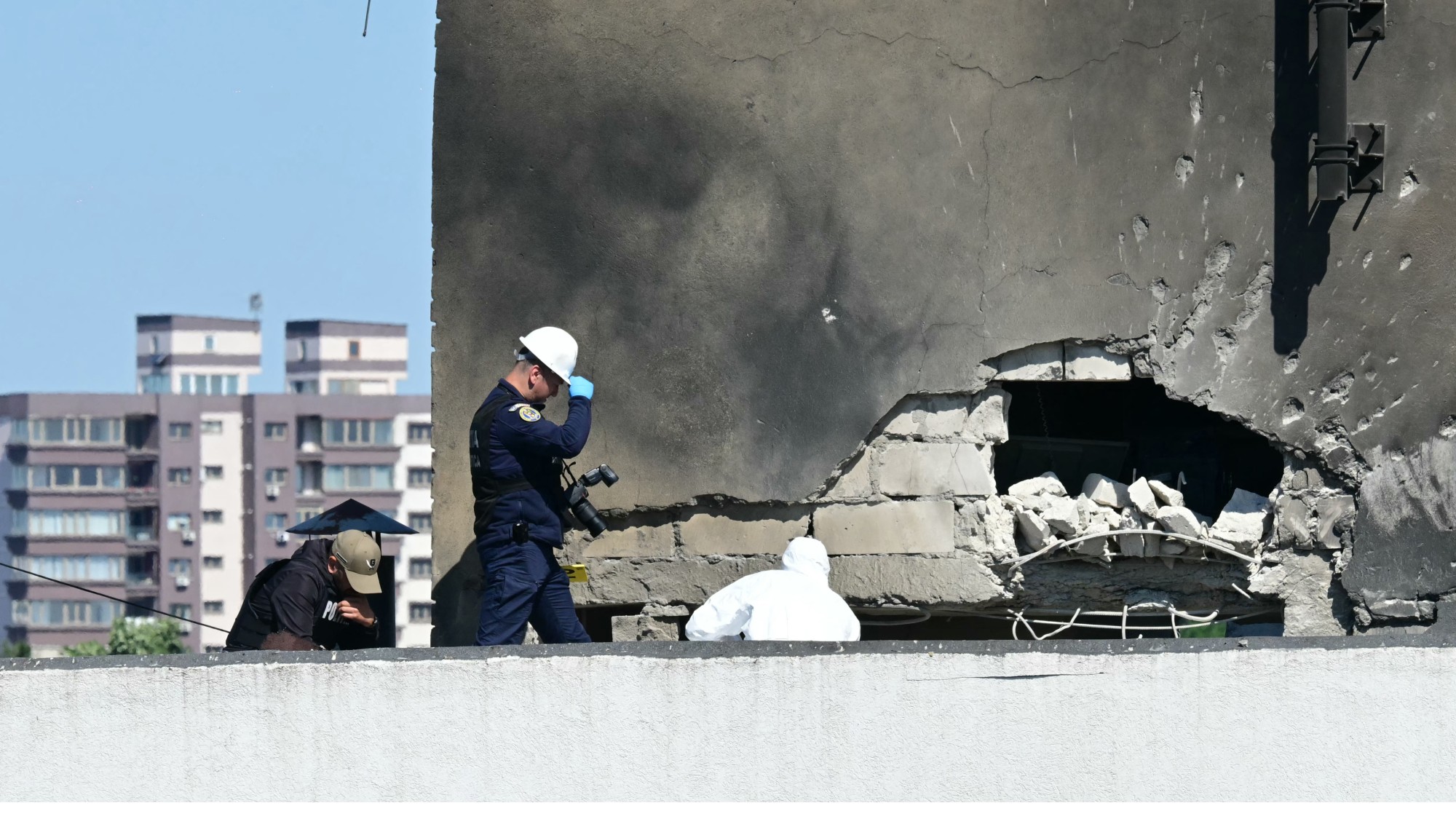 Police and forensic investigators examine the location of impact after a Russian drone struck an apartment building in Galati, eastern Romania