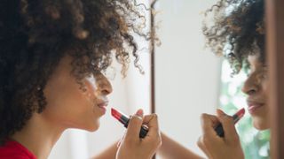 woman applying makeup