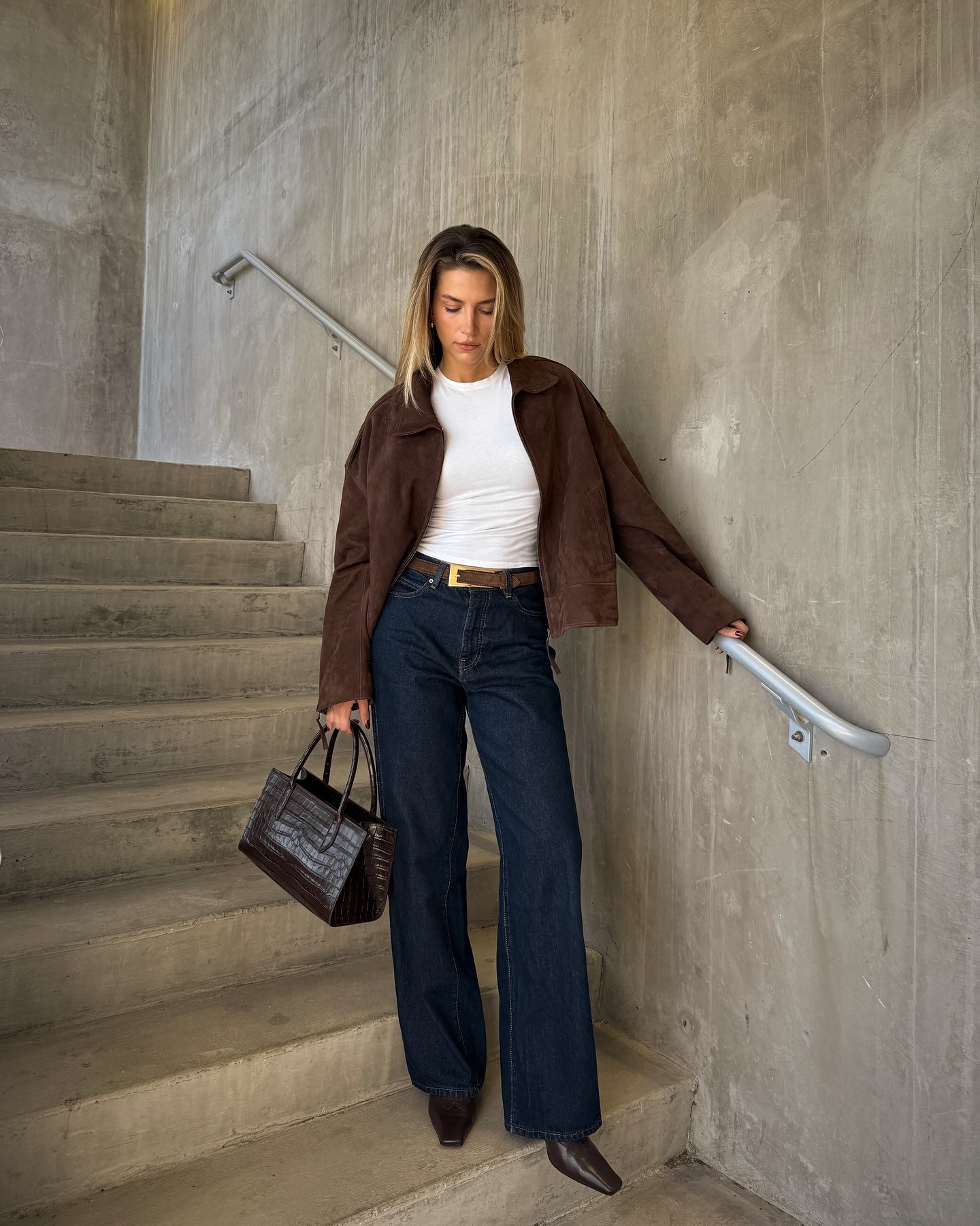 Influencer wearing straight-leg jeans and low-heel ankle boots