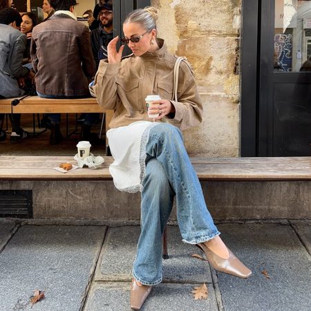 collage of style influencer Izzy Dilger sitting at a wood bench outside a cafe in Paris, France wearing sunglasses, a tan suede jacket with funnel neck, lace-trim dress, bootcut jeans, and neutral slingback kitten heels