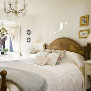 master bedroom with wooden bed and cream coloured bedding