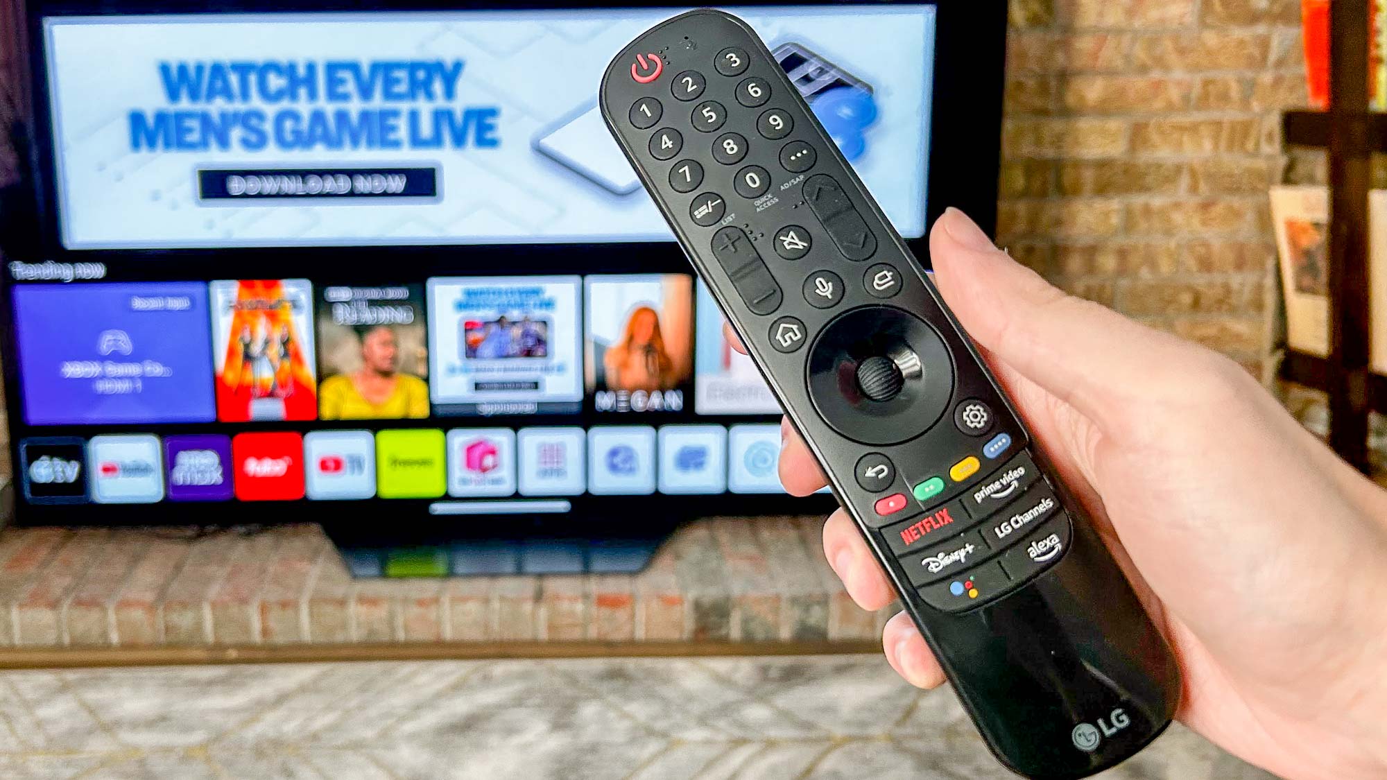 LG B2 OLED TV shown against a brick wall in a living room