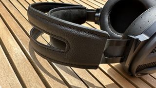 The FiiO FT3 over-ear headphones on a wooden surface