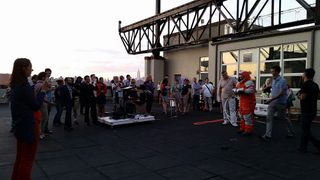 Final Frontier Design's Ted Southern and Nikolay Moiseev demonstrate their company's Spacesuit Experience, which allows customers to try on a pressurized spacesuit, during an invite-only event on a rooftop at the Brooklyn Navy Yard in Brooklyn, New York, on Aug. 28, 2014. NASTAR space training center director Brienna Henwood demonstrated the spacesuit during the event.
