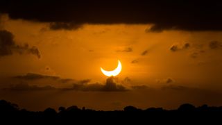 the moon appears to take a bite out of the sun during a partial solar eclipse whereby the sun now takes on a crescent shape. 