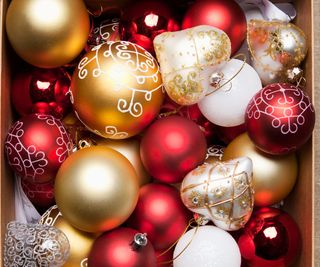A box of red, white, and gold christmas baubles