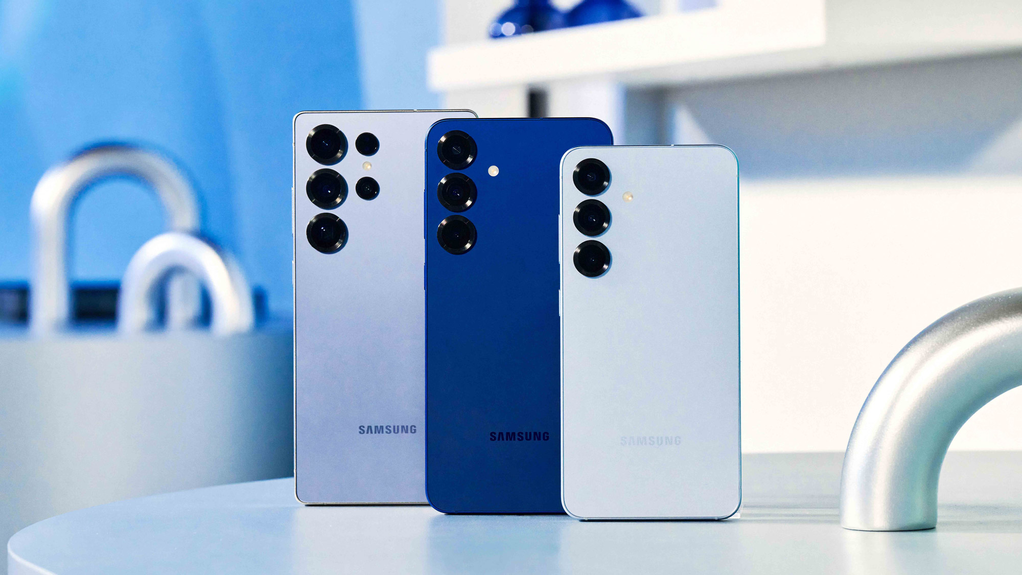 A Samsung Galaxy S25 Ultra, S25 Plus and S25 standing on a white table top.