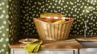rustic utility room with green and white daisy patterned wallpaper from Little Greene