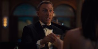 No Time To Die Daniel Craig toasts in a hurry