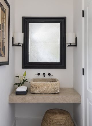 white powder room with stone sink by BHDM Design