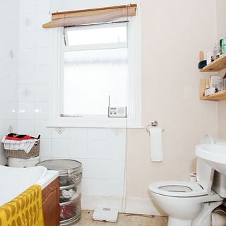 bathroom with commode and window