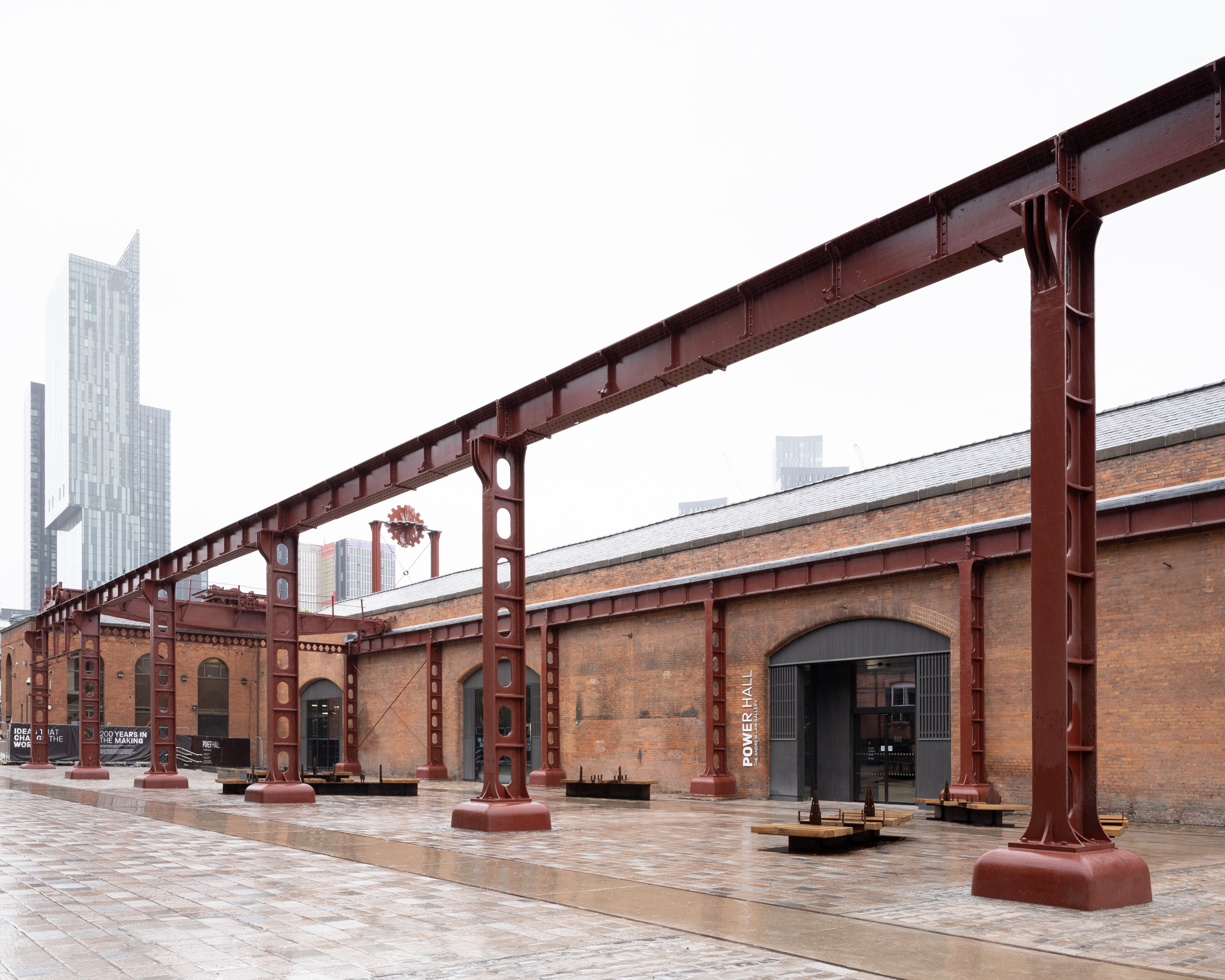 Power Hall by Carmody Groarke, a renovated warehouse with large machines, like old locomotives