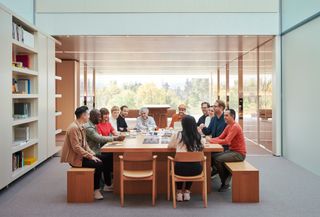 View of the Apple Design Team sitting around a meeting table inside Apple Park, Cupertino