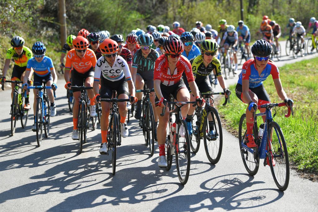 The peloton pushes hard on a climb