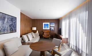 Hotel Nomma room with wooden round table and sofa table