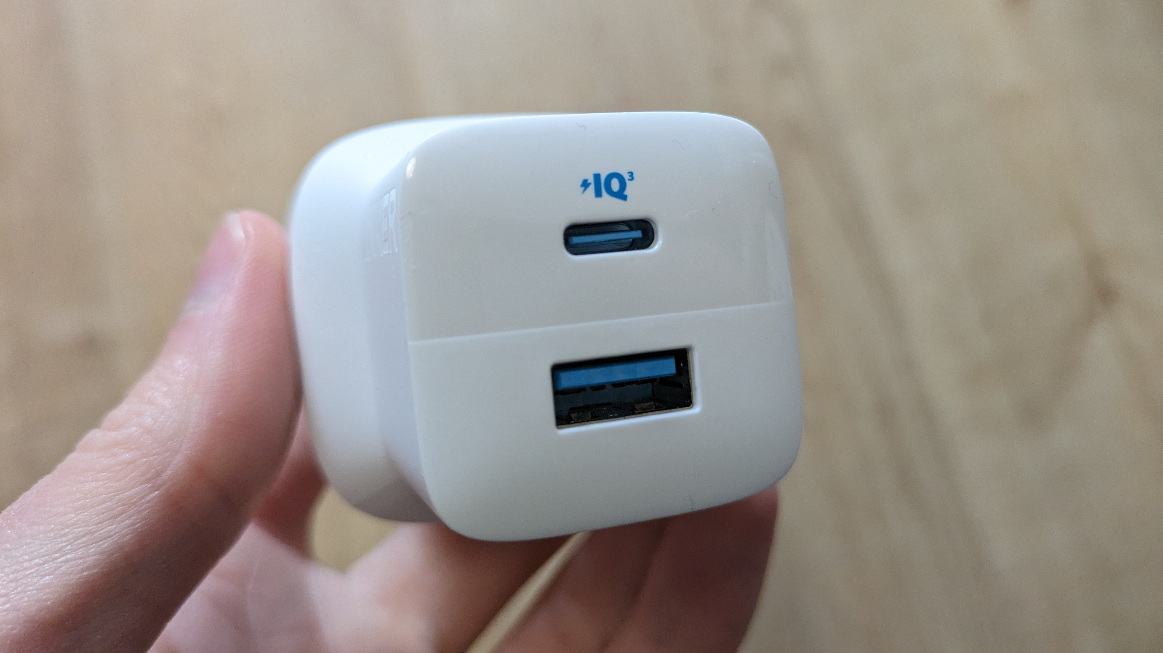 Anker 323 charger charger held in a hand, with USB-C and USB-A ports visible