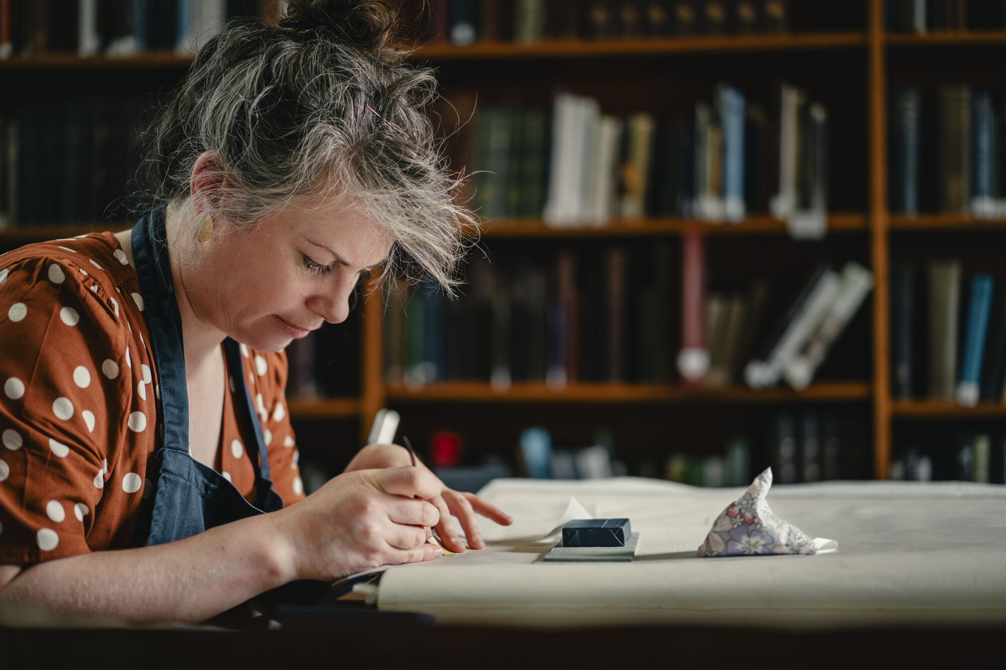 Conservator Rebecca Goldie works on the Birds of America books by John James Audubon in the library of the Royal College Physicians and Surgeons of Glasgow
