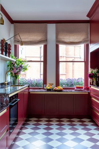 Kitchen with burgundy units and aubergine and white checkerboard floor