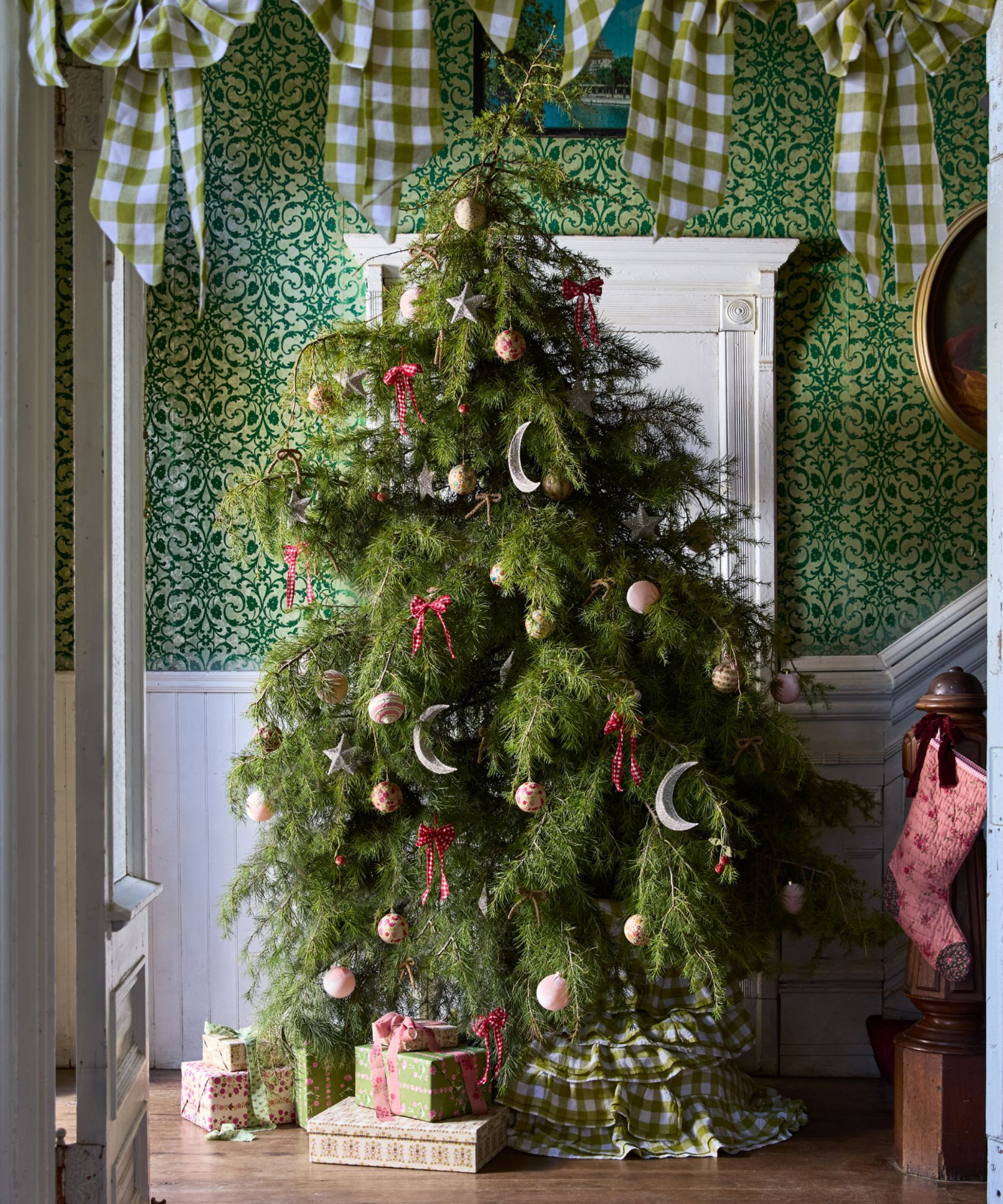 a large, whimsical Christmas tree from GreenRow decorated with bows and ornaments
