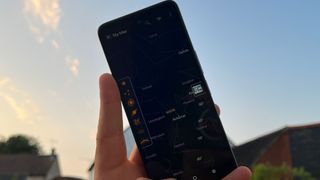 Sky Map app open on a smartphone pointed towards a dusky sky.