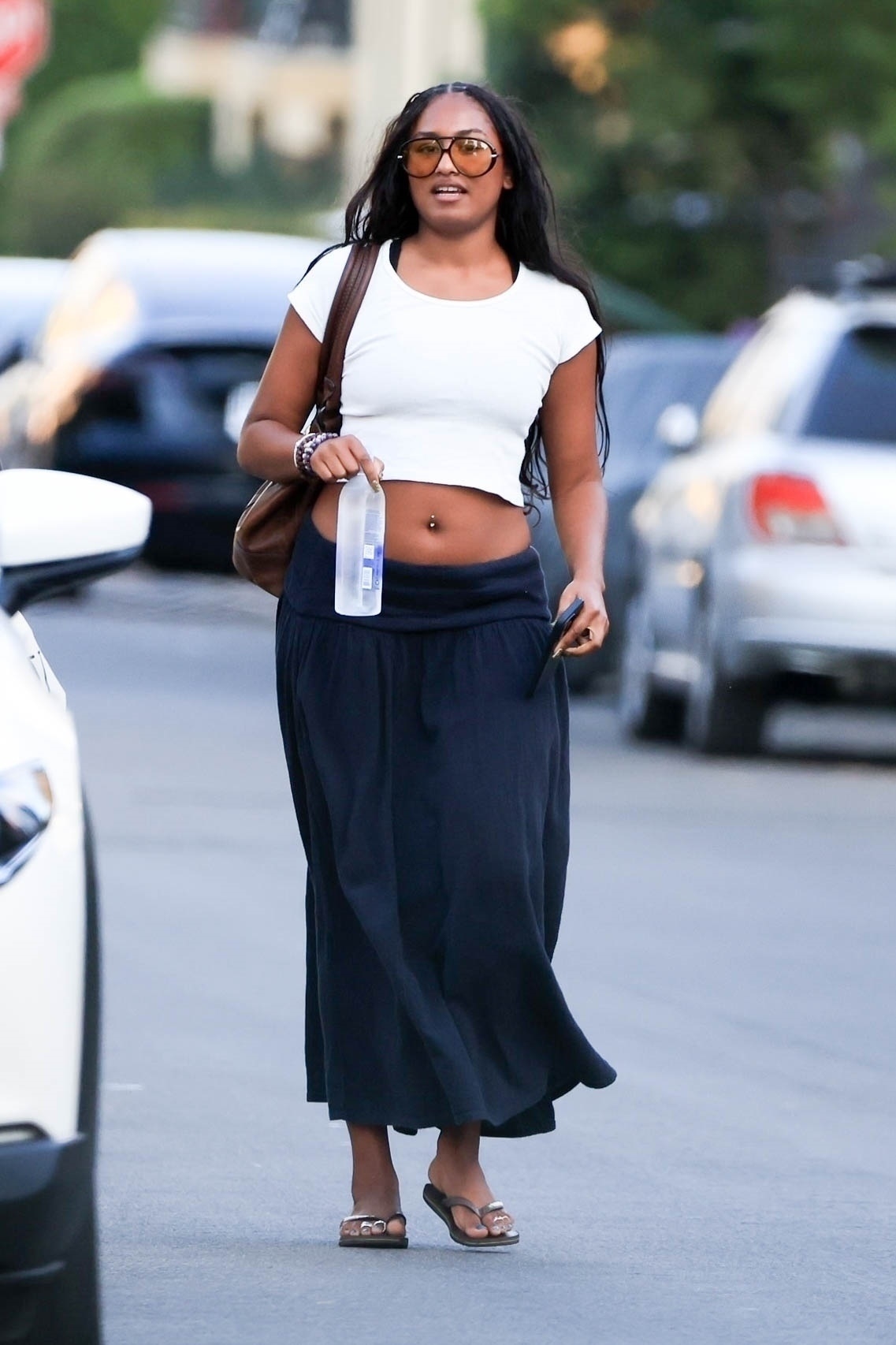 Sasha Obama in Los Angeles wearing a white cropped top and a black long skirt