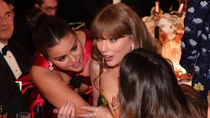 Taylor Swift talks to Selena Gomez at the 81st Golden Globe Awards 
