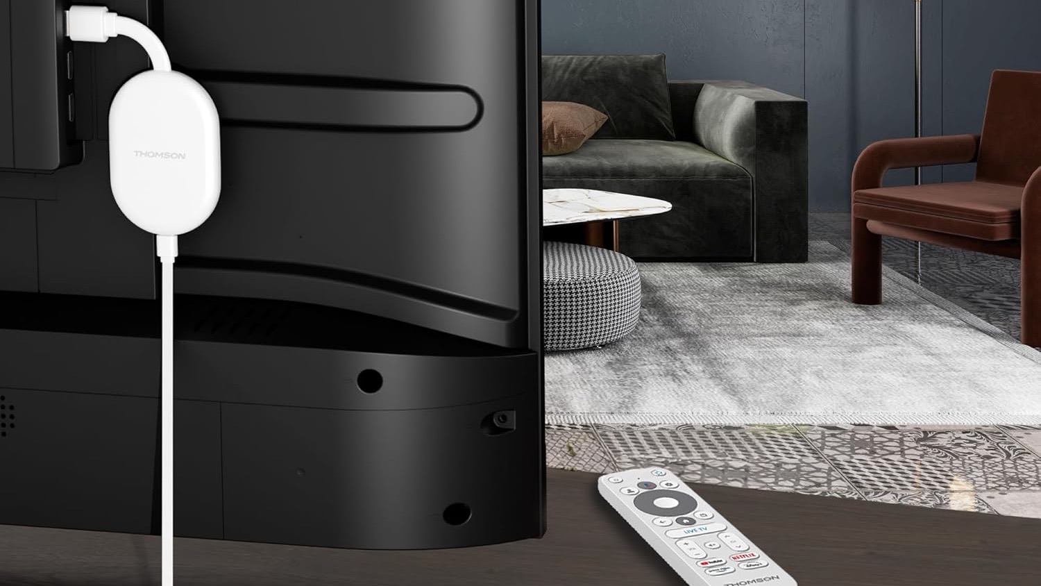A white Thomson Go Cast streaming dongle plugged into the back of a TV in a modern lounge. A white Thomson remote control is visible on the TV cabinet.