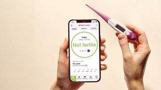 A Natural Cycles user holding a thermometer, and a phone with the screen showing "Not fertile"