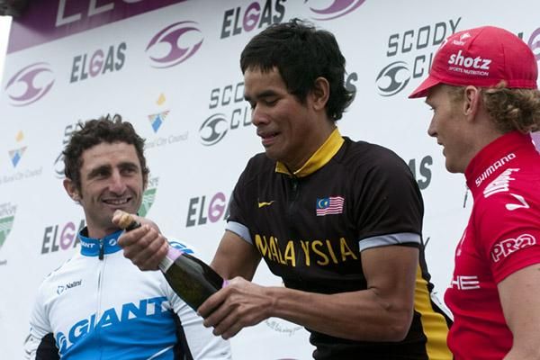 Stage winner Harrif Saleh (Malaysian National Team) may need some practice popping the corks as runner-up Rico Rogers (left) of the Swan Hill Rural City Council team and Stuart Shaw (3rd,Drapac Porsche) look on.