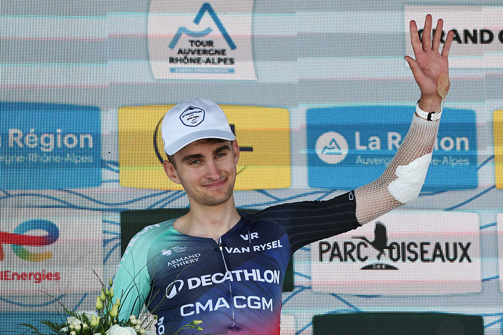 Decathlon CMA CGM Team's French rider Paul Seixas celebrates on the podium with the most combative rider award after the 7th stage of the Tour Auvergne-Rhone-Alpes cycling race (formerly known as the Criterium du Dauphine), 133,6km between La Bridoire and Grand Colombier in the French Alps on June 13, 2026. (Photo by Anne-Christine POUJOULAT / AFP)