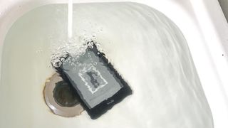 The Kindle Paperwhite 2021 in a filling sink