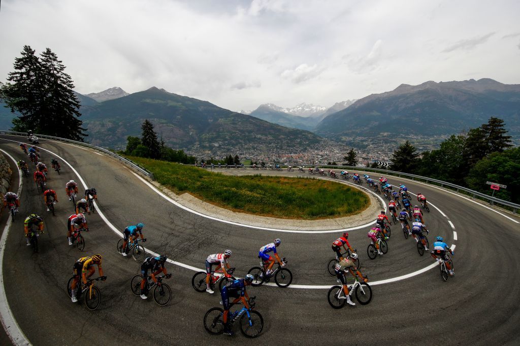 Riders cycle down towards Aosta Rear during the 15th stage of the Giro dItalia 2022 cycling race 177 kilometers from Rivarolo Canavese Piedmont to Cogne Aosta Valley on May 22 2022 Photo by Luca Bettini AFP Photo by LUCA BETTINIAFP via Getty Images