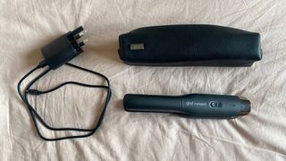 ghd Unplugged Cordless Styler with its case and charger