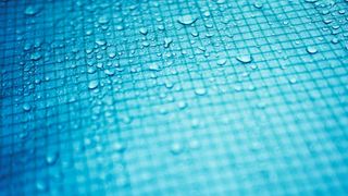 Close up of water droplets on grid surface