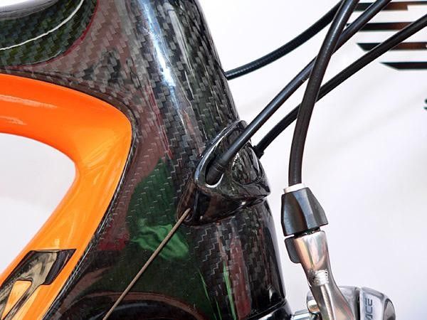 The aluminum head tube badge and housing stop